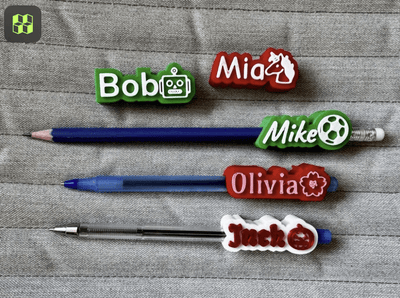 Pens with name labels on a textured surface