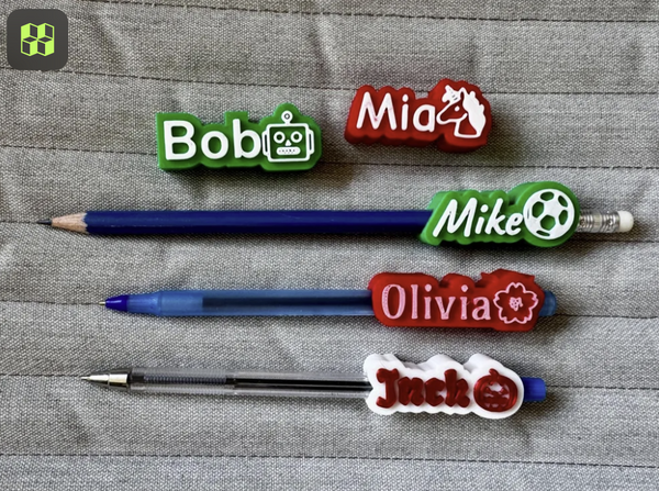 Pens with name labels on a textured surface
