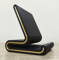 Black 3D printed mobile holder with gold-tone trim against a light background